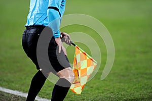 Assistant referee signalling with the flag