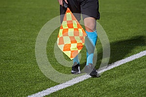 Assistant referee walking along the sideline during a soccer mat