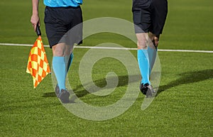 Assistant referee walking along the sideline during a soccer mat