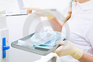 Assistant with sterile dentist tools