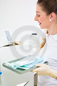 Assistant with sterile dentist tools