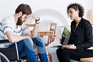 Assistant talking with invalid patient photo