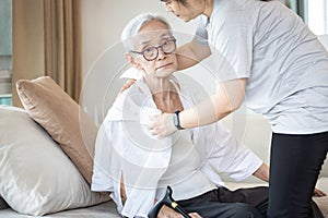 Assisting in dressing,asian female caregiver taking care of helping senior woman get dress,chang clothes for old mother,Alzheimer