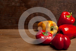 Assort of different shape and color bell pepper on wooden background