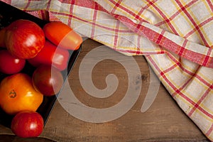 Assort of different shape and color tomatoes on wooden background