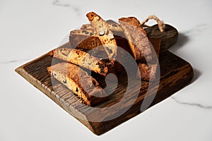 Assorted Almond and Cranberry Biscotti on Rustic Wooden Board, Artfully Arranged with Marble Backdrop