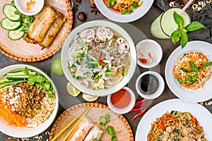 Assorted asian dinner, vietnamese food. Pho ga, pho bo, noodles, spring rolls top view