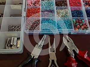 Assorted beads in various sizes and colors in clear plastic case