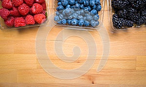 Assorted Berries on wood background