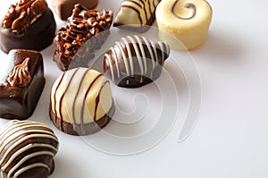 Assorted bonbons on a white table Top diagonal aligned