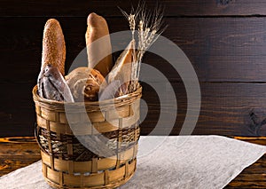 Assorted bread and baguettes in a rustic basket