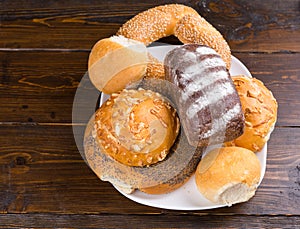 Assorted bread rolls and a bagel on a plate