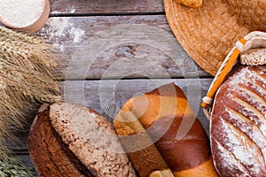 Assorted bread on wooden background.