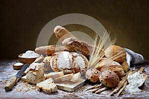 Assorted bread on wooden pastry board.