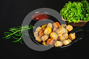 Assorted Breaded Chicken nuggets.Semi-finished chicken variety chicken nuggets on a dark background with fresh herbs