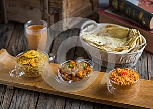 Assorted break fast set balalet or balaleet, aloo nakhi,aloo karahi, tomato egg with bread and coffee served in a dish isolated on