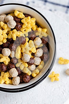 Assorted breakfast cereals: chocolate balls and honey stars