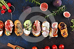 Assorted bruschetta with various toppings. Appetizing bruschetta or brie crostini. Variety of small sandwiches. Mix bruschetta on