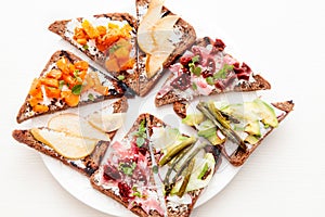 Assorted bruschetta with various toppings. Variety of small sandwiches. Mix bruschetta