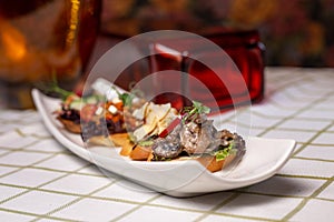 assorted bruschetta on a white plate on the table