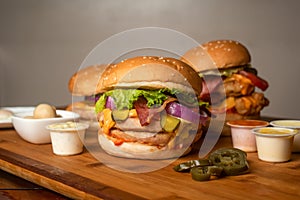 Assorted Burgers with Crispy Chicken Cheese burger with beef bacon isolated on wooden table top view of frech Junk fastfood