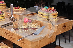Assorted cakes on display, one with a slice removed. Reflects the joy of indulging in handcrafted bakery delights.