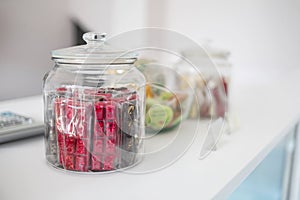 Assorted candies in a glass jar display