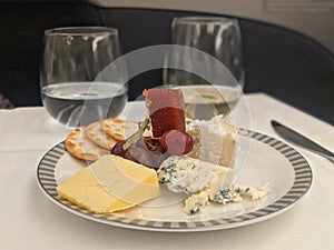 Assorted Cheese, crackers and grapes on serving luxury beautiful plate.