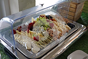Assorted cheese platter in a glass display chiller