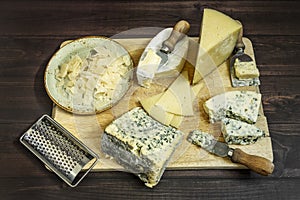 assorted cheese still life with knives and scrapers