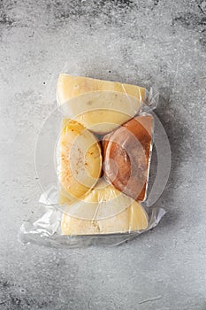 Assorted cheese in a vacuum packaging. Top view