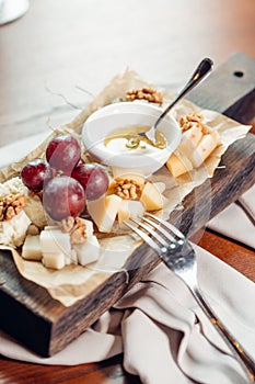 Assorted cheeses with honey and nuts