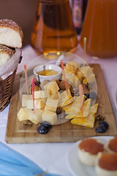Assorted cheeses on a wooden Board.
