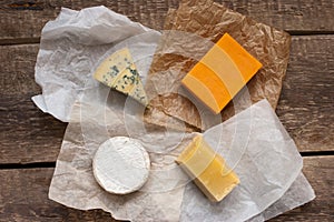 Assorted cheeses on the wooden table