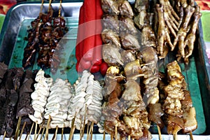 Assorted chicken and pork innards and hotdog in barbecue sticks sold as street food in the Philippines