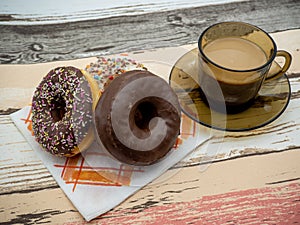 Assorted choco donuts and cup of coffee