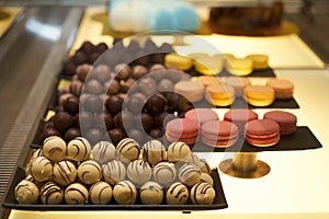 Assorted chocolate candies in a pastry shop, close-up.