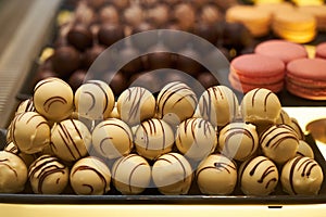 Assorted chocolate candies in a pastry shop, close-up.