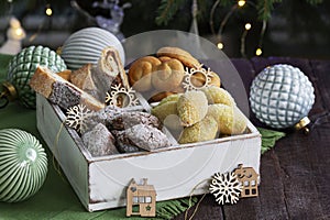 Assorted Christmas cookies with different fillings, Christmas decorations on a wooden background. Rustic style.