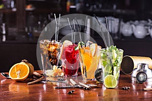 Assorted cocktails in glass glasses on a wooden stand