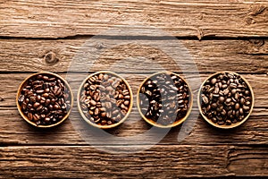 Assorted coffee beans on a driftwood background