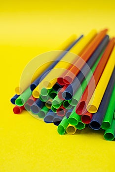 Assorted Color Straws On Vibrant Yellow Studio Background