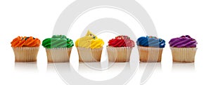 Assorted colored Cupcakes with sprinkles on white