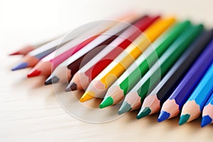 Assorted colored pencils in a row, closeup, School supplies.