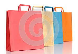 Assorted colored shopping bags over white