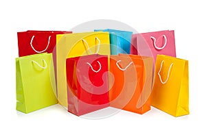 Assorted colored shopping bags on white