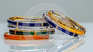 Assorted Colorful Bangles of Gold, Silver, and Enamel on White Surface
