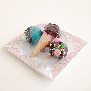 Assorted colorful cupcakes in ice cream cones