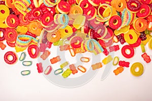 Assorted colorful gummy candies. Top view. Jelly donuts. Jelly bears. Isolated on a white background