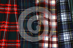 Assorted colorful hanging tartan kilts photo